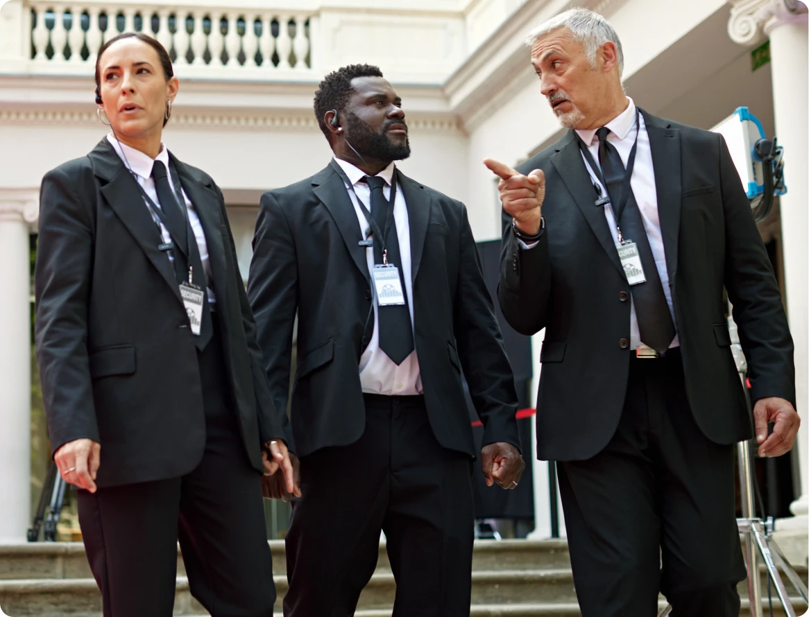 Three professionals in suits conversing