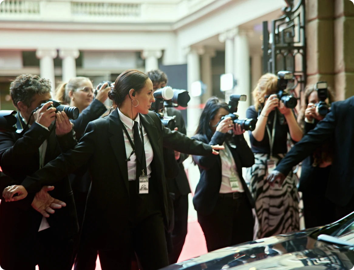 Bodyguards escort individual at event